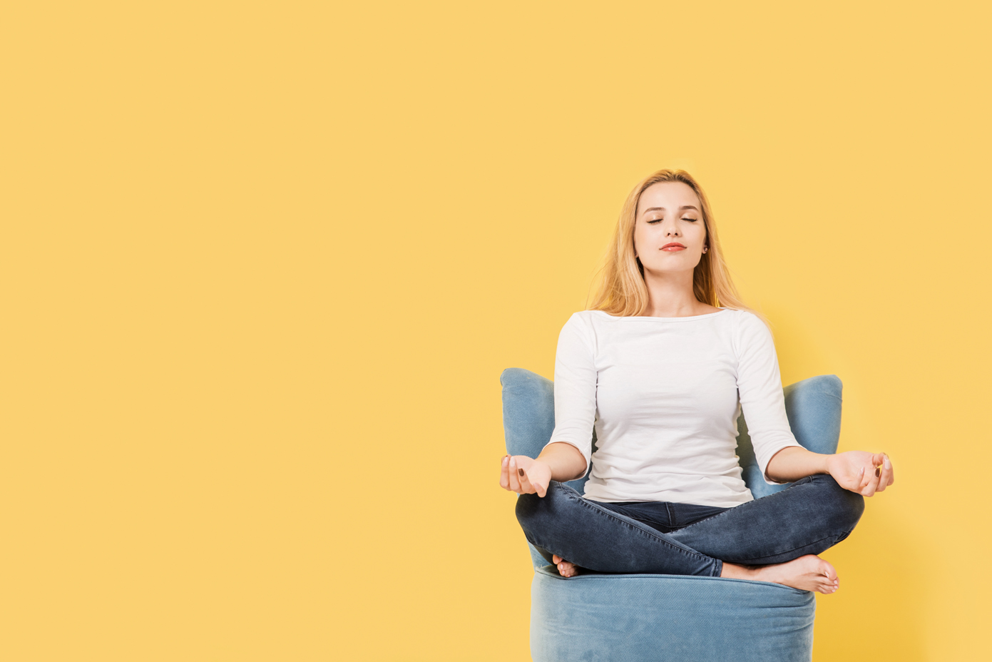 Young woman relaxing on chair. Picture includes copy space